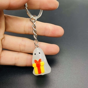 Glow-in-the-dark ghost keychain with yellow gift box made of translucent resin material