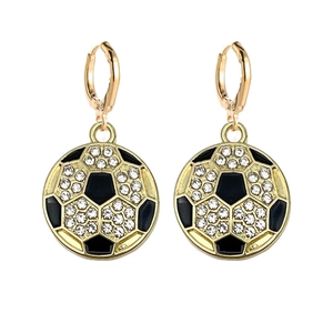 Close-up of golden soccer ball earrings featuring sparkling crystals and black enamel