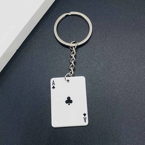 Close-up of Ace of Clubs poker card pendant keychain with silver metal ring