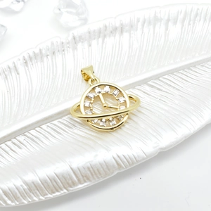 18k gold plated creative planet clock pendant with cubic zirconia stones on white tray
