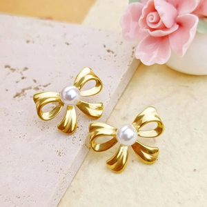 Elegant gold bow earrings with white pearl center made of durable stainless steel