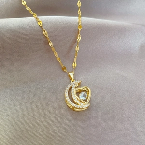Elegant gold moon and heart pendant necklace with shimmering crystals on S-link chain