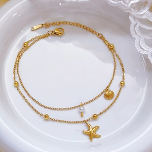 Gold double-layered stainless steel anklet featuring starfish, seashell, and pearl charms