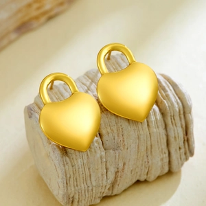 Elegant gold heart lock stud earrings with a brushed metal finish in a minimalist style