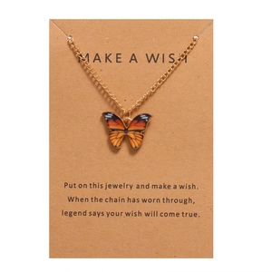 Bohemian butterfly pendant necklace with orange patterns on a Make a Wish gift card