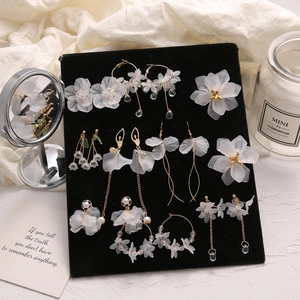 Elegant white petal drop earrings and floral hair accessories set with gold metal finish