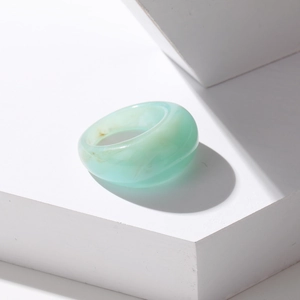 Minimalist light green resin ring with marble texture on white geometric stone