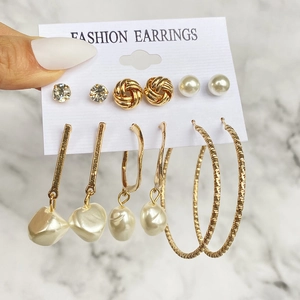 Dettaglio set di 6 orecchini in lega dorata con strass e perle su cartoncino display
