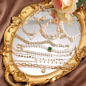 Vintage gold-plated layering bracelet set with pearls and emerald charm