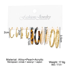 Detail of 6-pair gold alloy hoop earring set with acrylic and pearl charms on a display card
