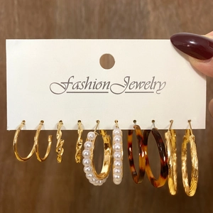 Detailed set of 5 vintage gold-tone hoop earrings with pearls and resin textures