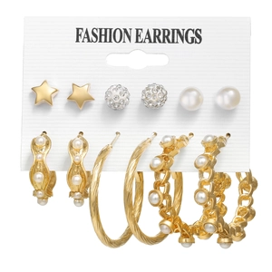 Detail view of fashion earring set with gold stars, pearls, and large hoop earrings on card