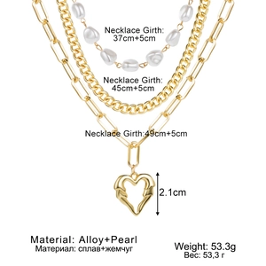 Three-layer gold necklace set with heart pendant and pearls in a layered style