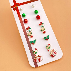 9-pair Christmas earring set with pearls, reindeer, and festive trees on a display card