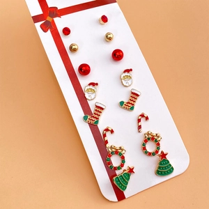 Detail of Christmas earring set featuring festive enamel motifs and red crystal charms