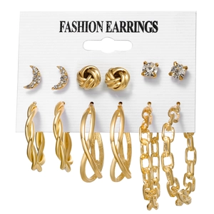 Set of 6 gold earrings featuring moon, chain loops, and stud designs on a white card