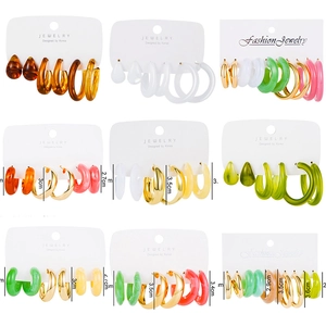 Detailed view of assorted acrylic and metal C-shape hoop earring sets on white cards
