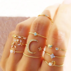 Detailed close-up of bohemian gold ring set with moon, star, and pearl embellishments