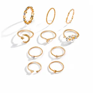 Detailed grid view of 10-piece gold alloy rings with star, moon, pearl and crystal motifs
