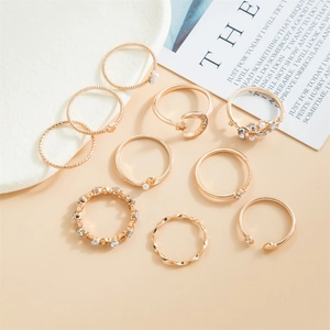 Detailed view of a 10-piece gold ring set featuring celestial motifs and pearls