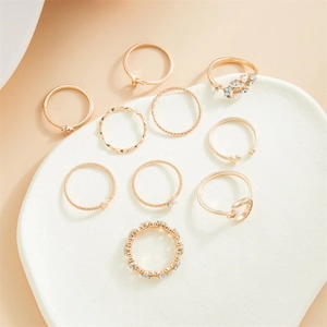 Set of 10 gold fashion rings for women featuring stars, moon, heart, and pearl details