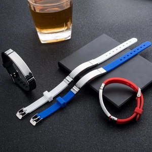 Close-up of silicone sports bracelets with polished metal plates in four assorted colors