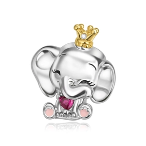 Macro detail of elephant charm with gold crown and pink heart stone in silver finish