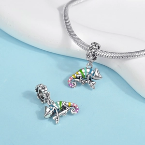 Macro shot of silver chameleon charm with colorful enamel stripes on a snake chain