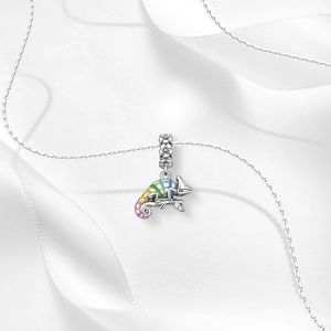 Detail view of chameleon pendant with colorful rainbow enamel and small diamond on branch