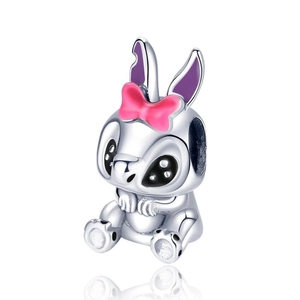 Detailed view of silver rabbit charm with pink bow and purple ears for beaded bracelet