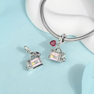 Detailed macro shot of S925 silver Love Pet charm with pink enamel and red heart stone