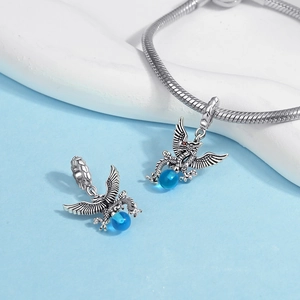 Detailed macro view of S925 silver dragon pendant with blue bead and vintage texture