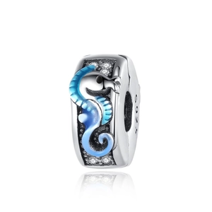 Macro detail of S925 silver bead charm with blue enamel seahorse and clear zircon stones