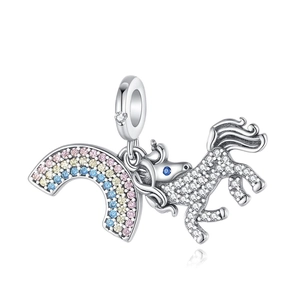 Macro detail of silver unicorn and rainbow charm pendant with sparkling crystals