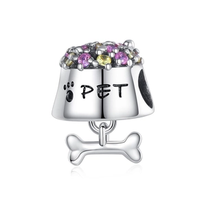 Detailed close-up of a heart charm with pet paw print, purple stones, and bone pendant