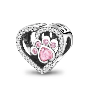 Close-up of heart-shaped silver charm with pink gemstone paw print and cubic zirconia