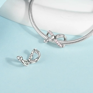 Macro shot of S925 sterling silver infinity charm with Forever Family engraving