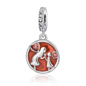 Macro shot of S925 silver heart charm with red mother-daughter silhouette and red gems