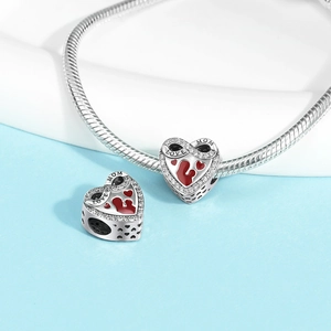 Detail of silver heart charm with red enamel LOVE MOM text and sparkling zircons