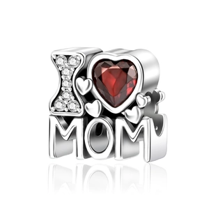 Macro shot of silver I Love MOM heart charm with sparkling red gemstone and zircons