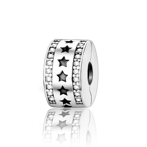 Macro shot of silver cylinder charm featuring black stars and sparkling zircon borders
