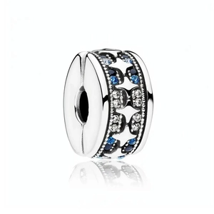 Macro shot of silver charm with hollow stars and blue zircons for DIY bracelets