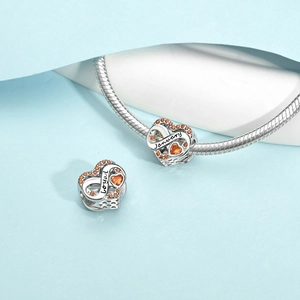 Detail of silver heart charm with orange zircon and infinity sign on snake chain