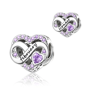 Detailed macro of heart charm with purple cubic zirconia for February birthstone jewelry
