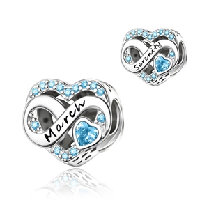 Detailed view of silver heart charm with light blue zircon and March Serenity engraving