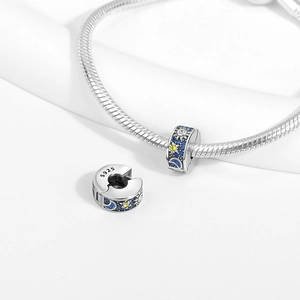 Detailed view of silver sun and moon charm bead with blue crystals and S925 hallmark