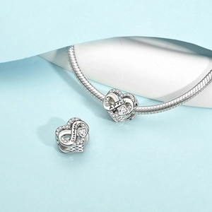 Silver infinity heart charm with April Strength engraving and white zircon inlay