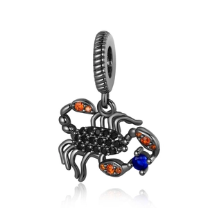 Macro shot of black scorpion pendant with inlaid orange and blue zircon stones