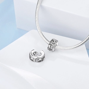 Detail of S925 silver star and moon charms with cubic zirconia on snake chain