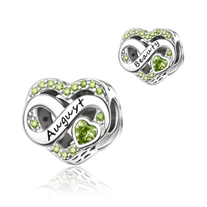 Detail of silver heart charm with August peridot stones and Beauty engraving